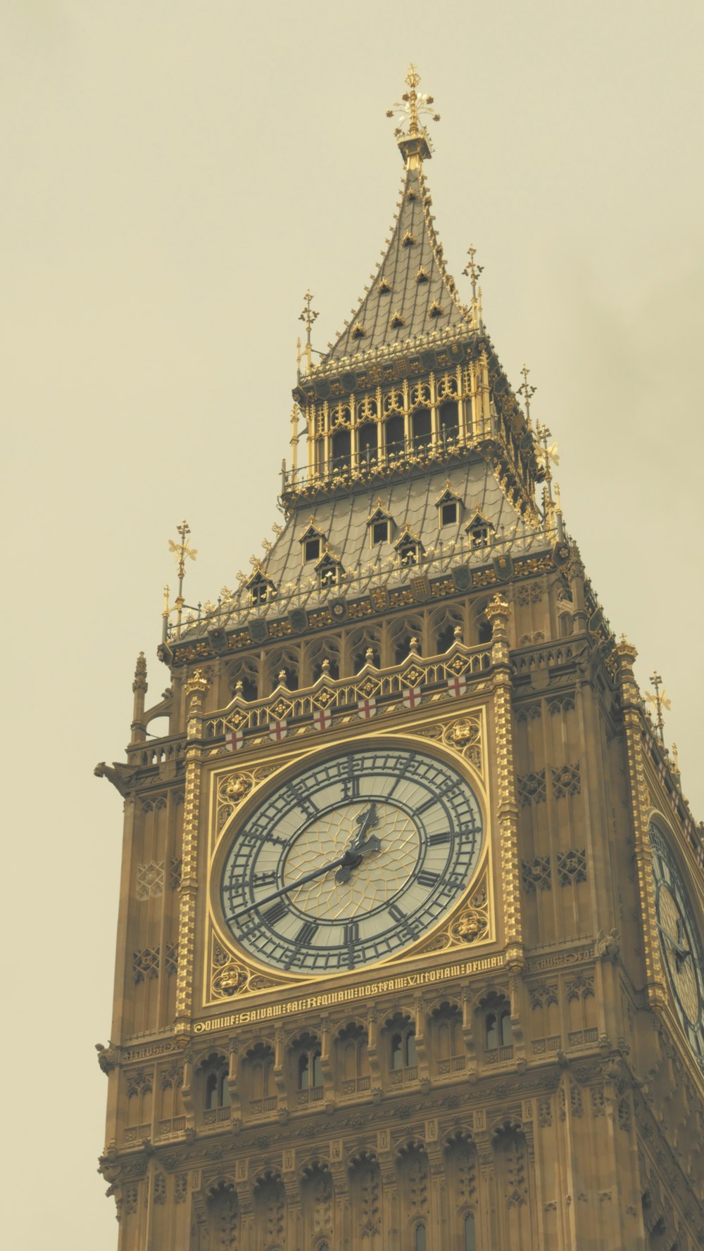 a tall clock tower with a clock on each of it's sides