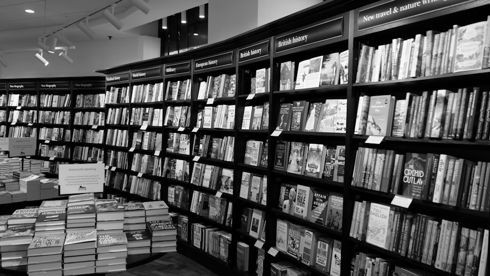 a black and white photo of a bookshelf full of books