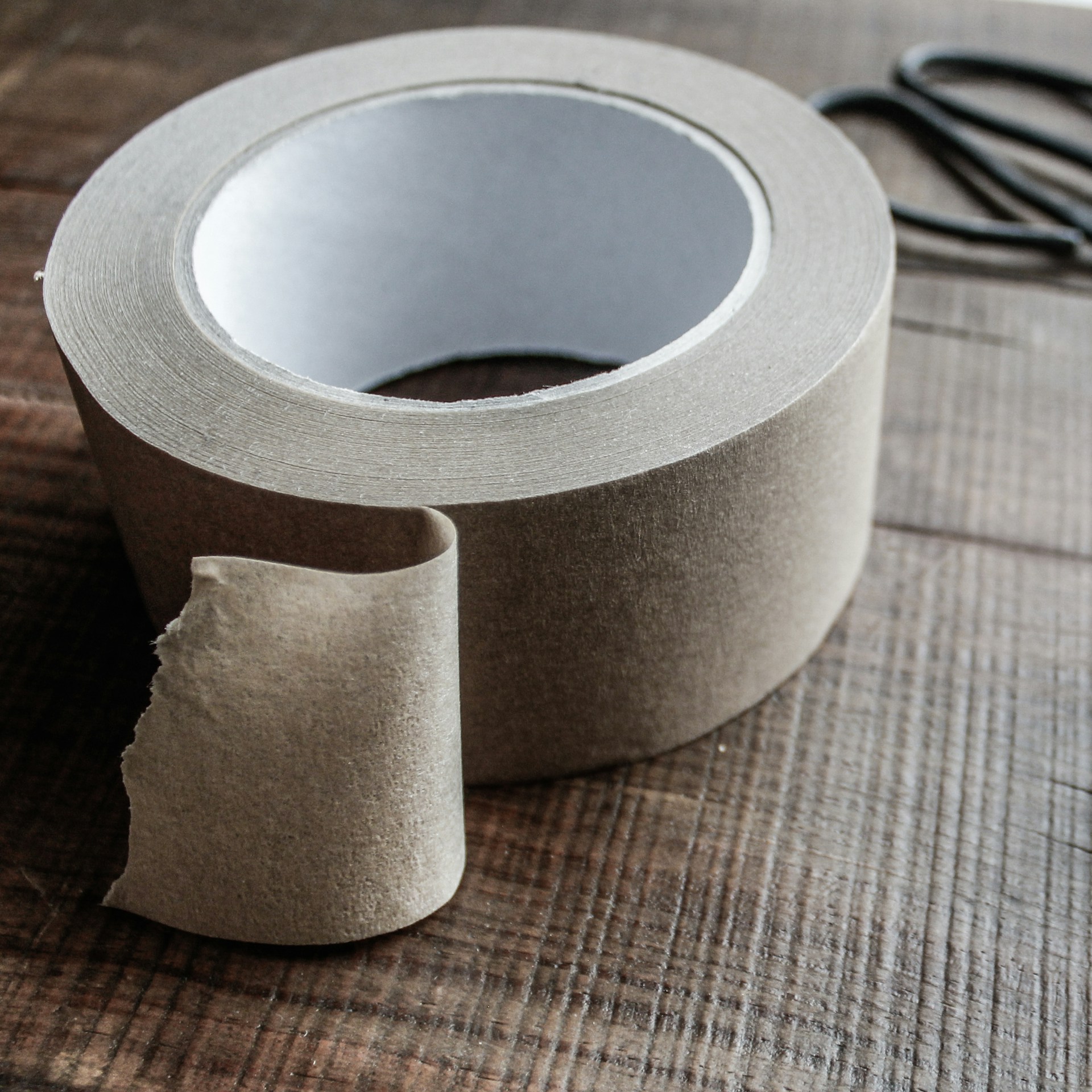 a roll of toilet paper sitting on top of a wooden table
