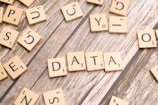 scrabble tiles spelling out the word data on a wooden surface