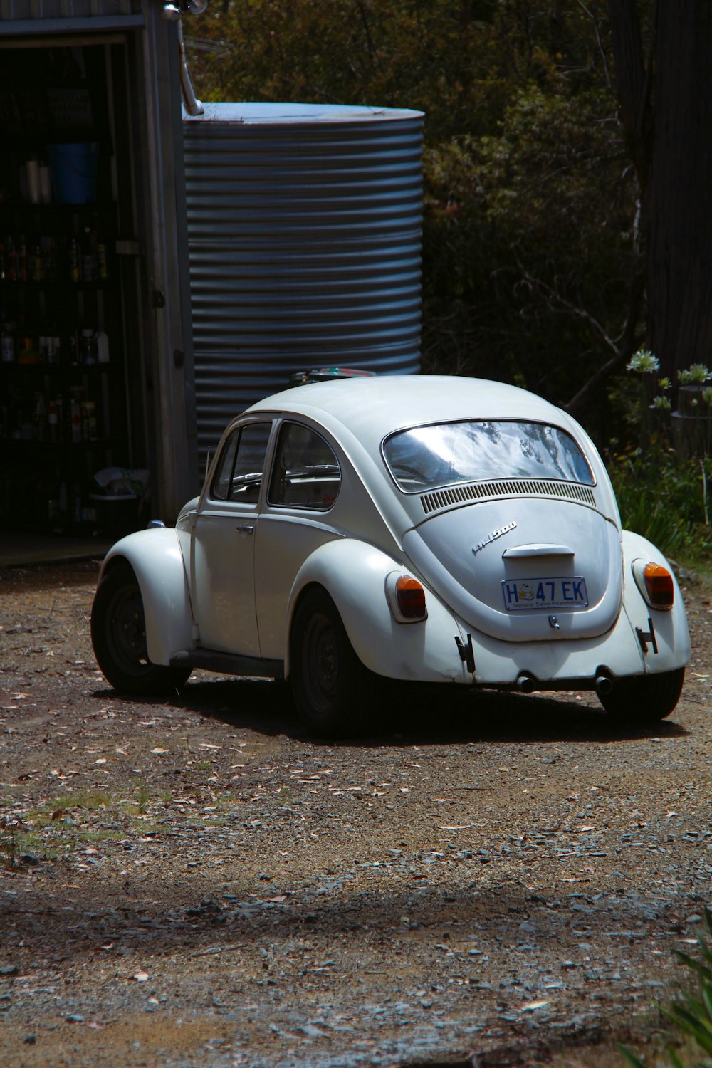 a white vw bug parked in front of a building