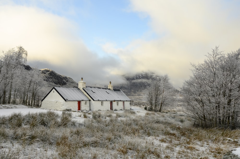 a house in the middle of a snowy field