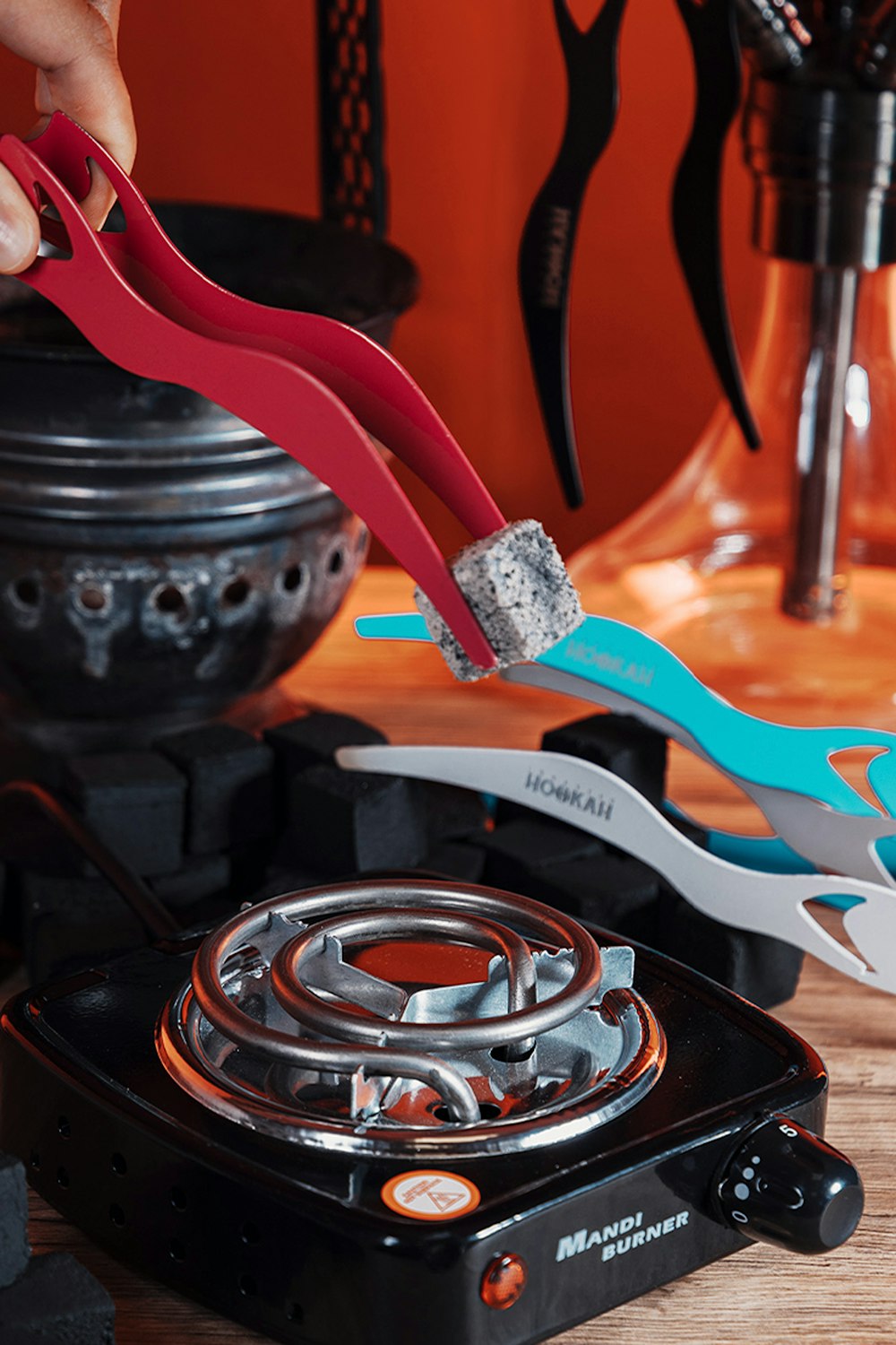 a person holding a pair of scissors over a stove