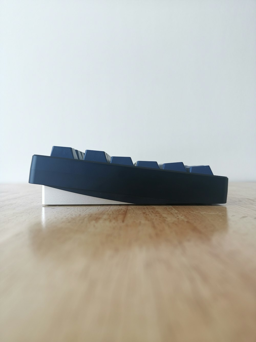 a wooden table topped with a blue and white shelf