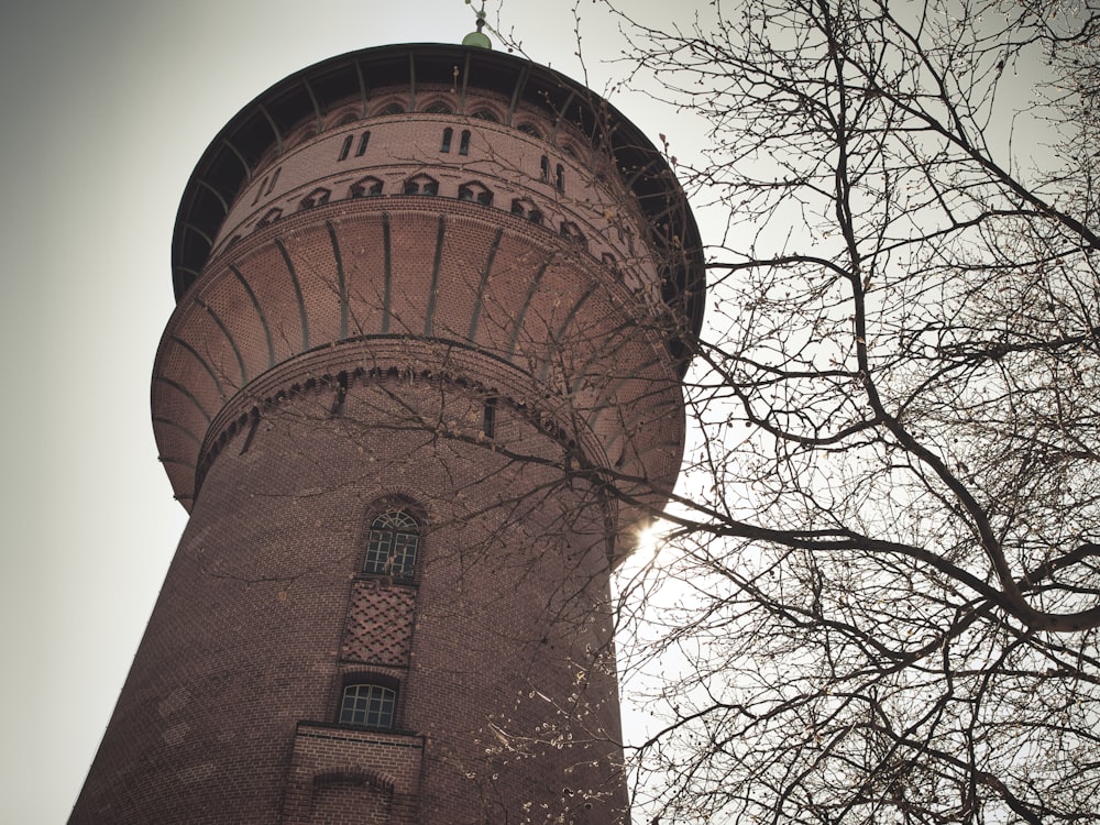 a tall brick tower with a clock on it's side