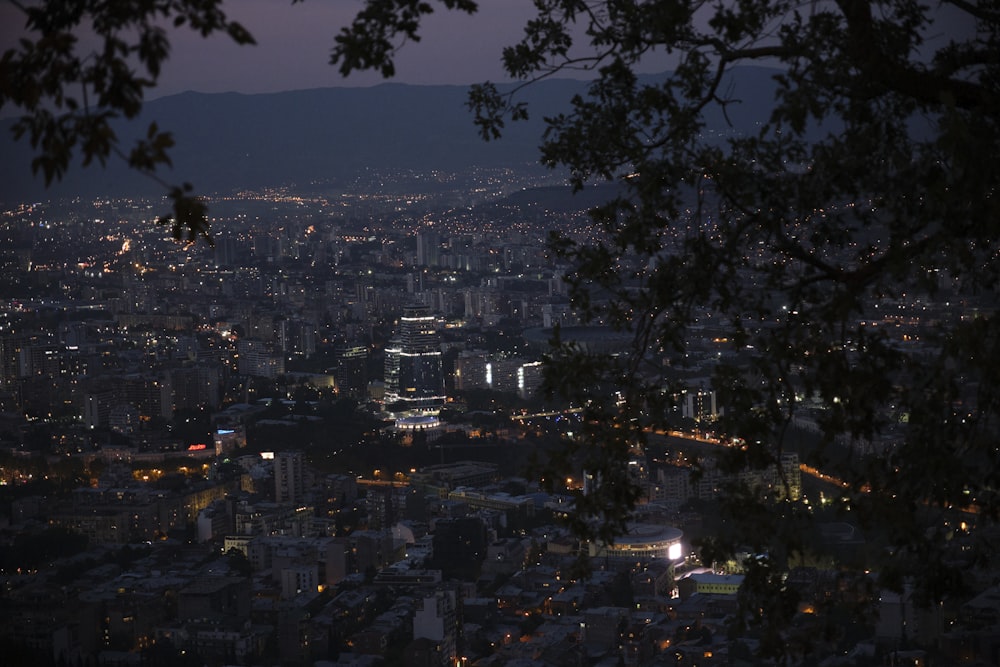 a view of a city at night from the top of a hill