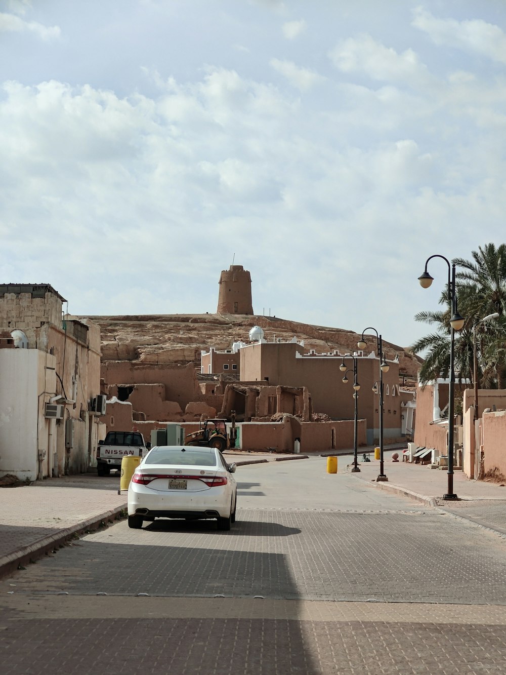 a white car parked on the side of a road