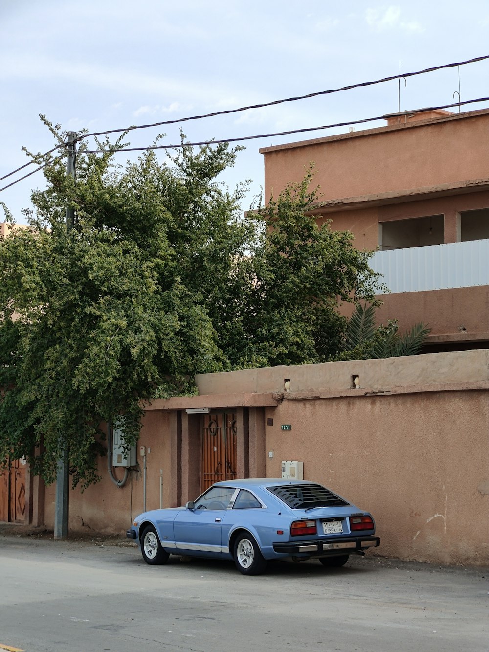 a blue car parked in front of a building