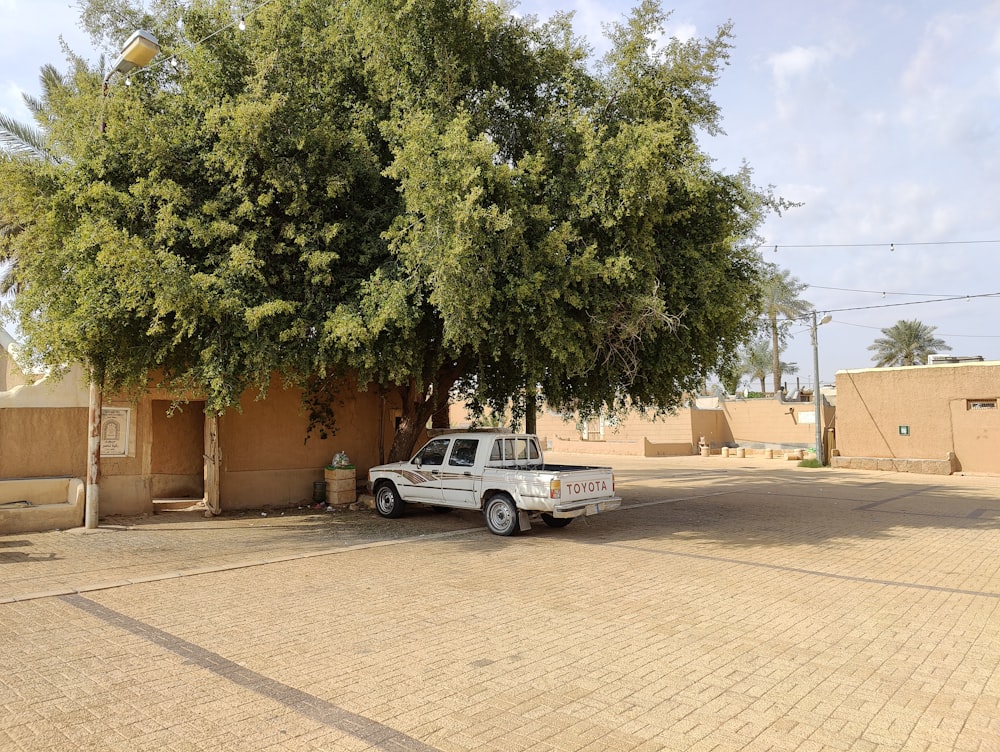 a truck is parked in front of a tree