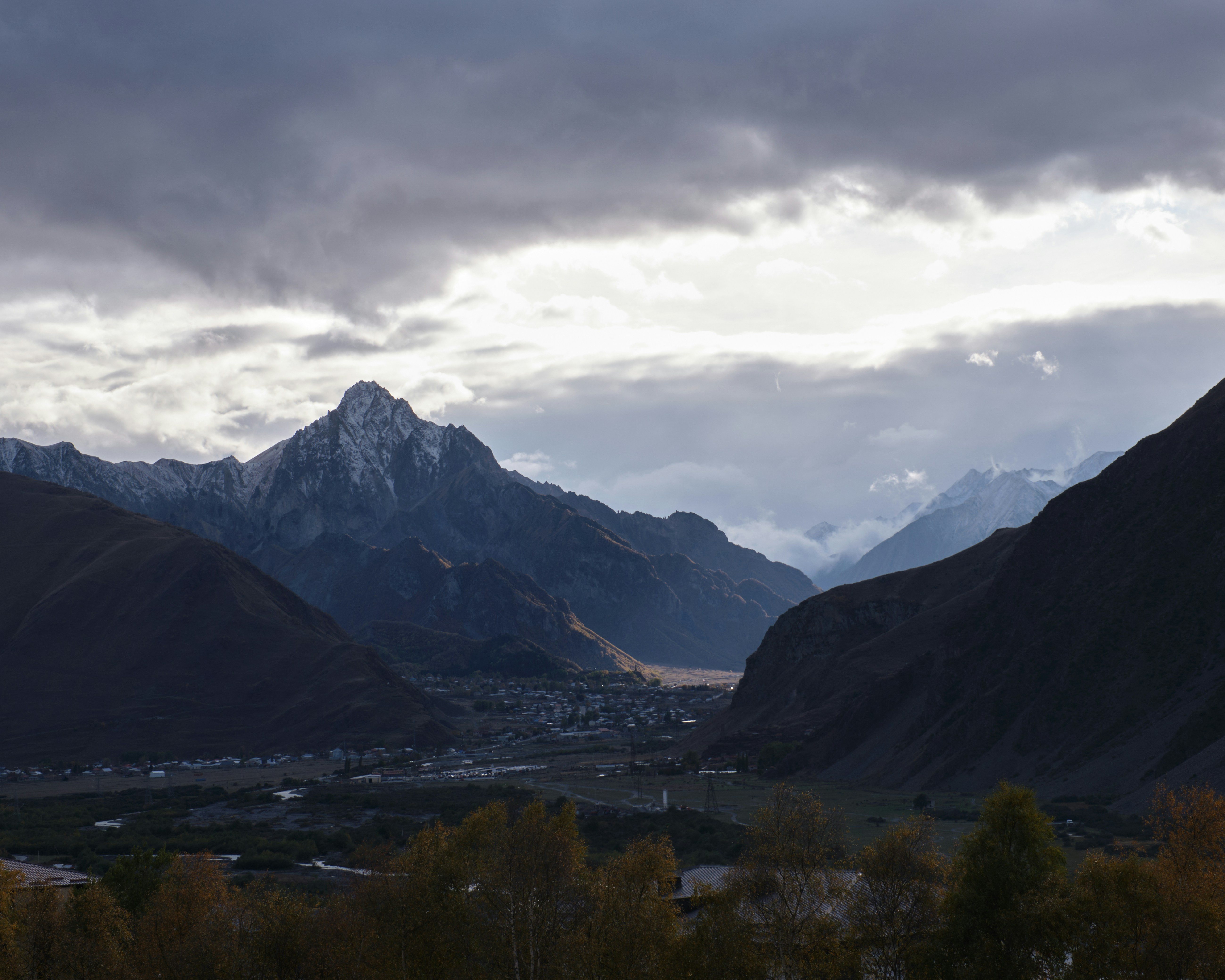 a view of a valley with mountains in the background