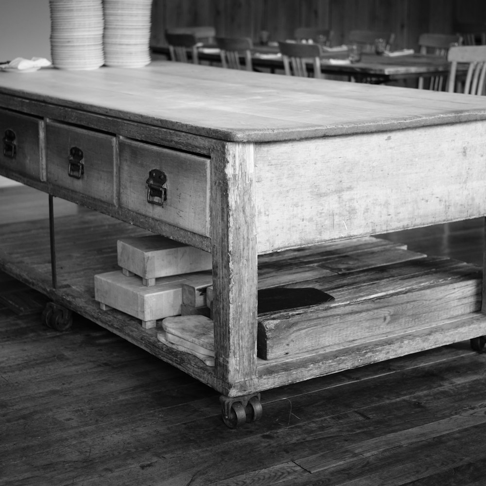 a table with drawers and plates on top of it