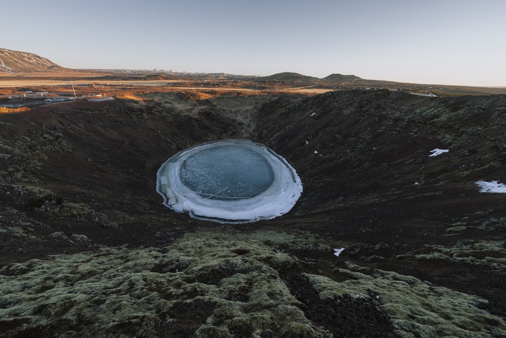 a frozen lake in the middle of a mountain