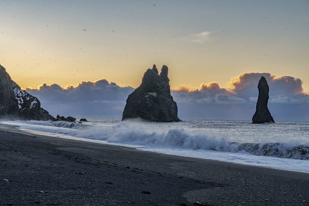 a beach that has some rocks in the water