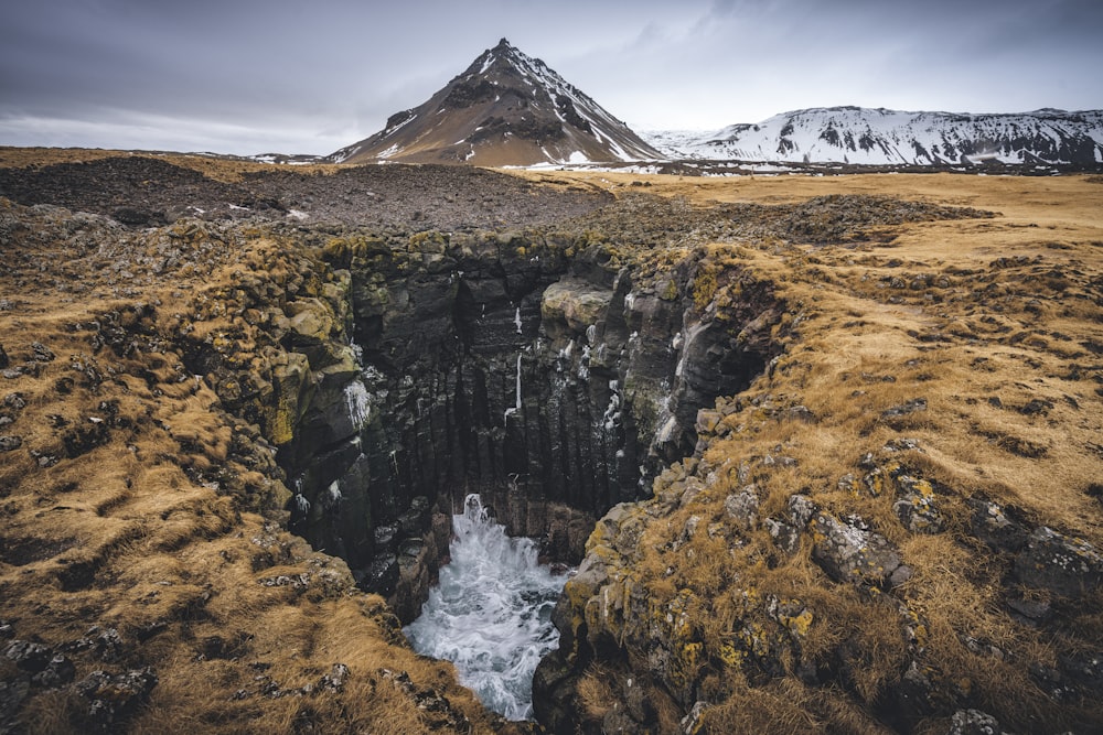 a mountain with a small waterfall in the middle of it