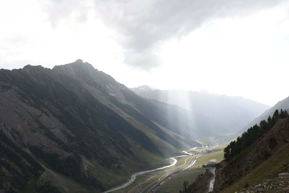 a view of a valley with mountains in the background