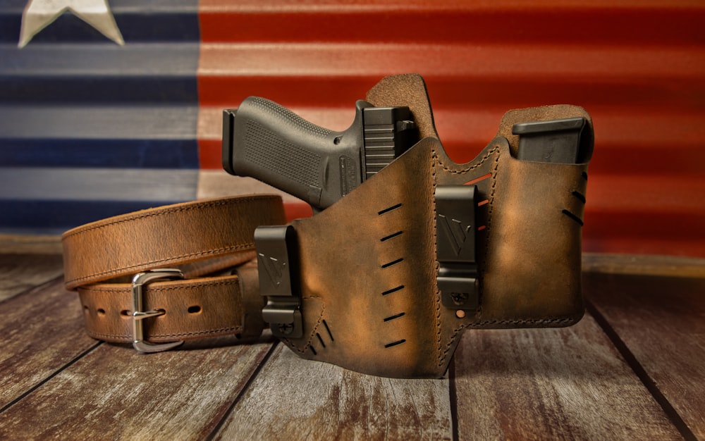 a leather belt with a gun inside of it