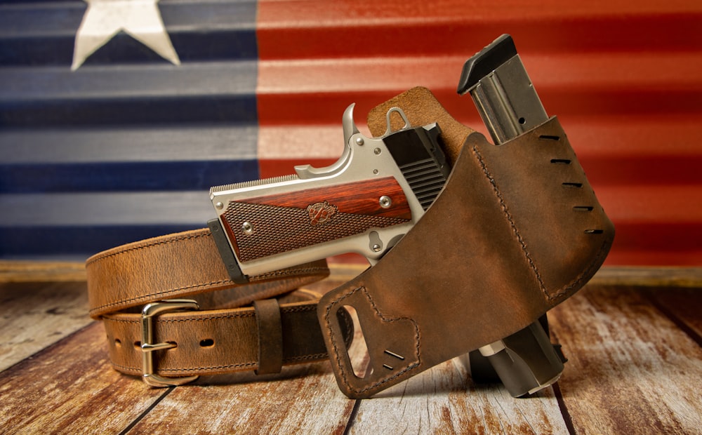 a leather belt with a gun inside of it