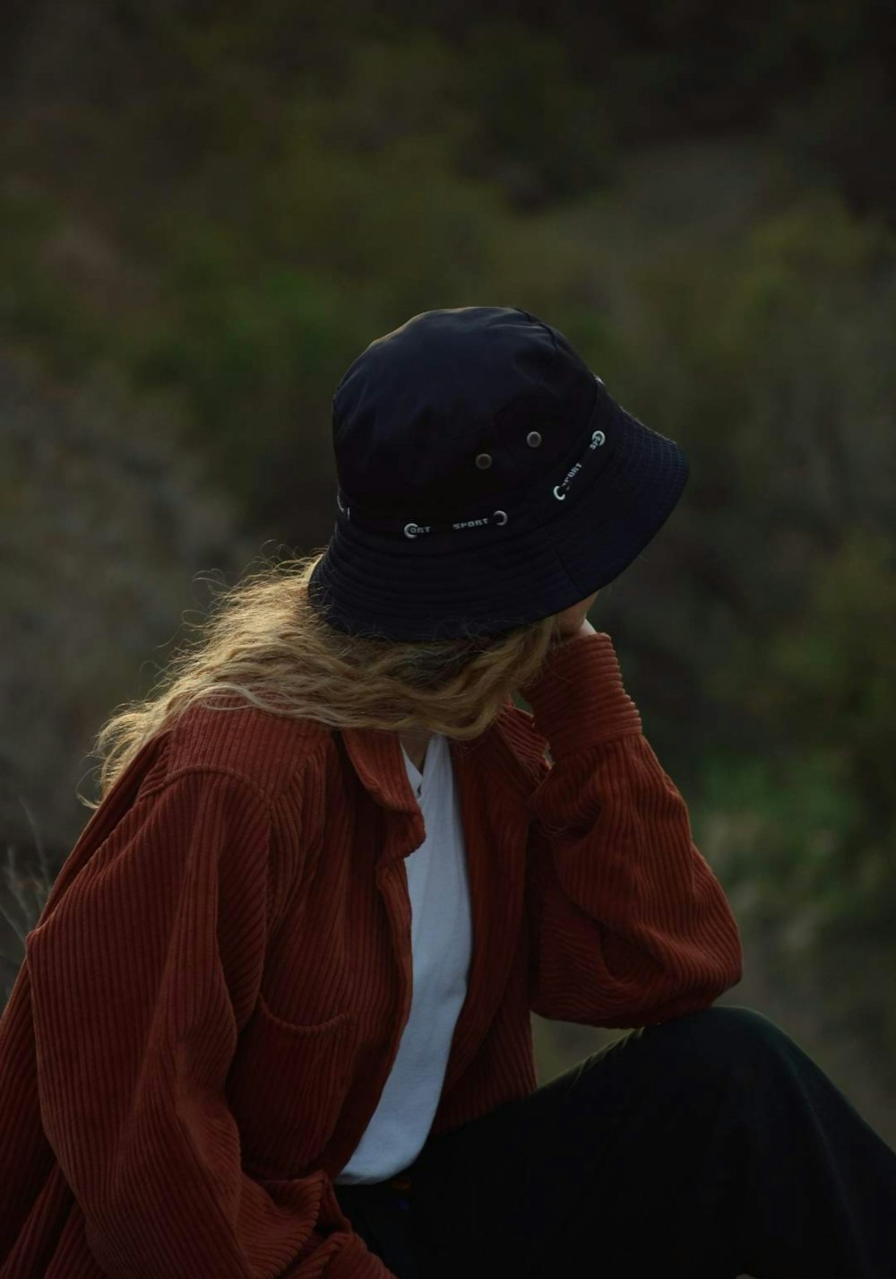 a woman in a red jacket and a black hat