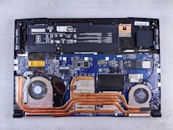 the motherboard of a laptop is being dismantled