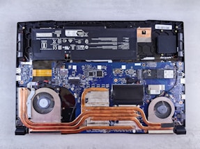the motherboard of a laptop is being dismantled
