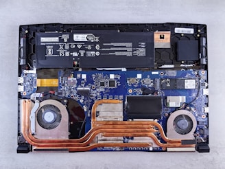 the motherboard of a laptop is being dismantled