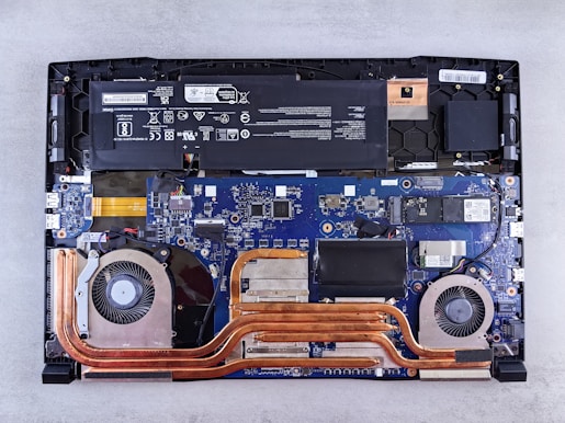 the motherboard of a laptop is being dismantled