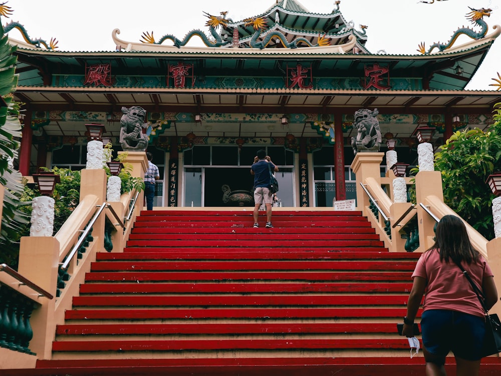 a couple of people that are walking up some stairs