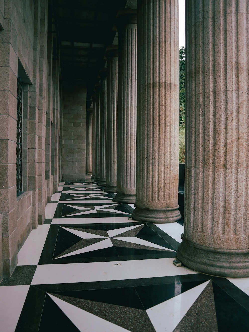 a black and white checkered floor with columns