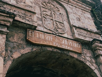 a stone building with a sign on it