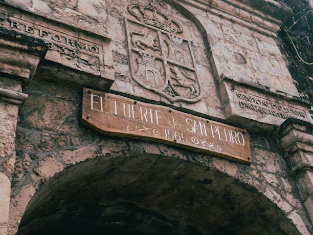 a stone building with a sign on it