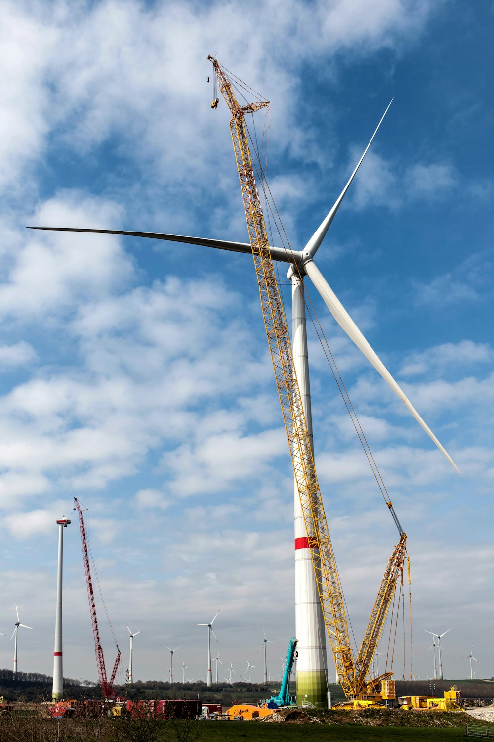 a large wind turbine sitting on top of a lush green field