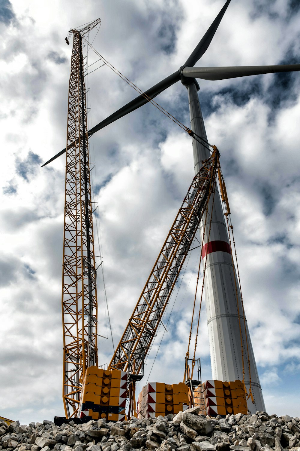 a large crane is standing next to a pile of rocks