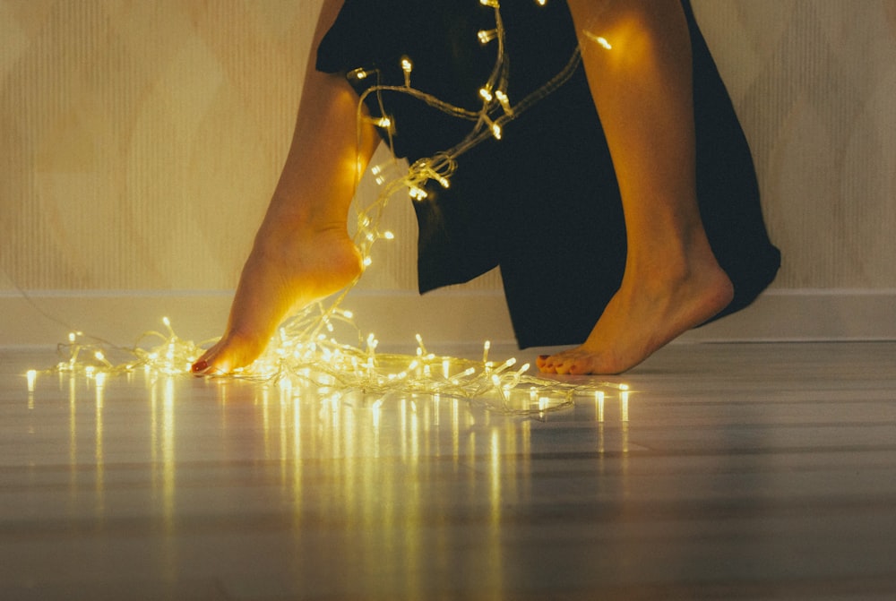a woman's bare feet with lights on them