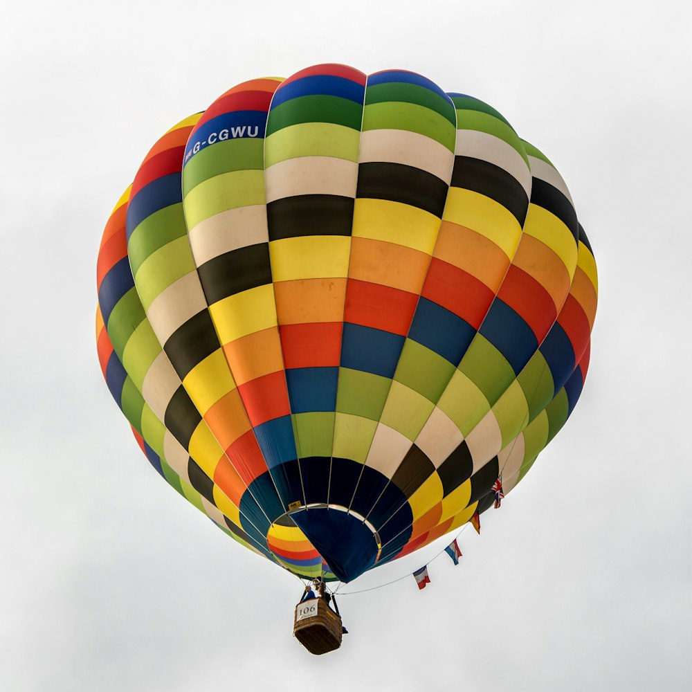 a large multicolored hot air balloon flying in the sky