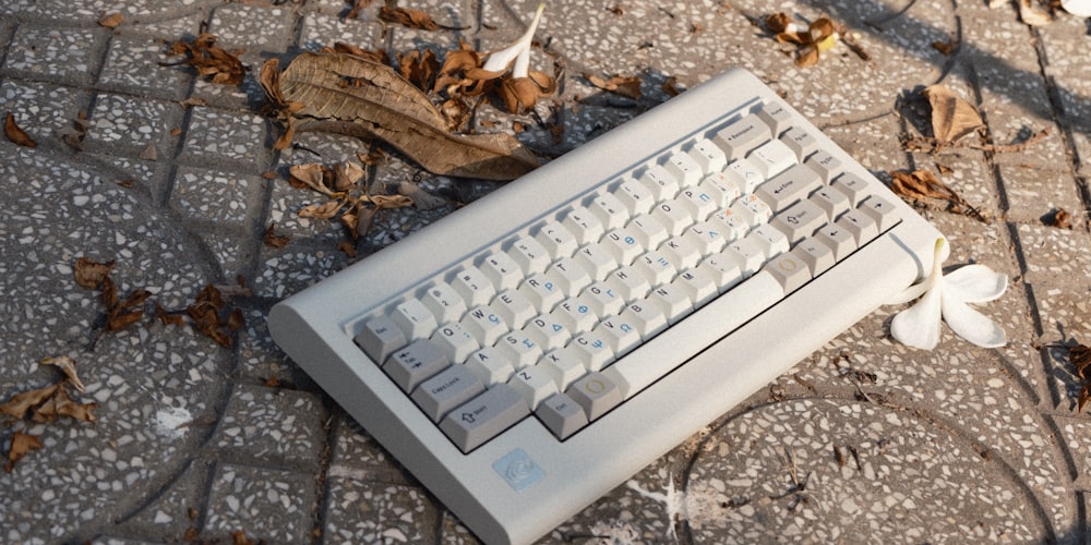 an old computer keyboard sitting on the ground
