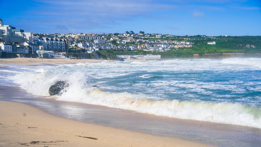 a view of a beach with houses in the background