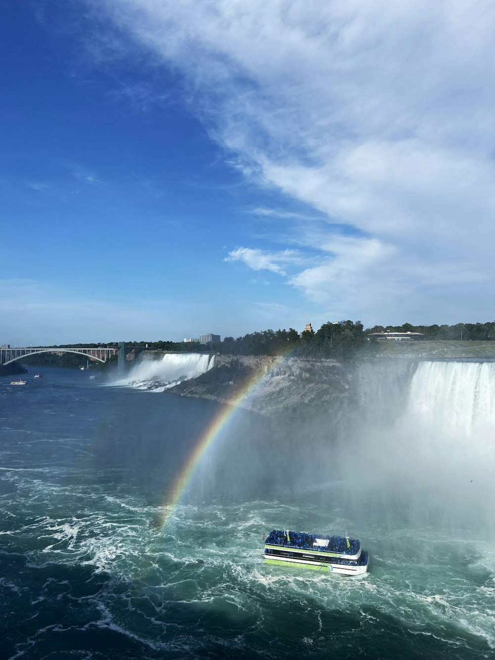 a boat that is in the water near a waterfall