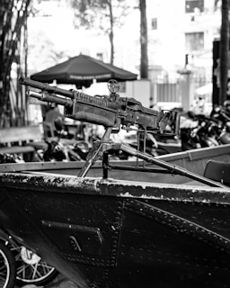 a black and white photo of a rifle on a boat