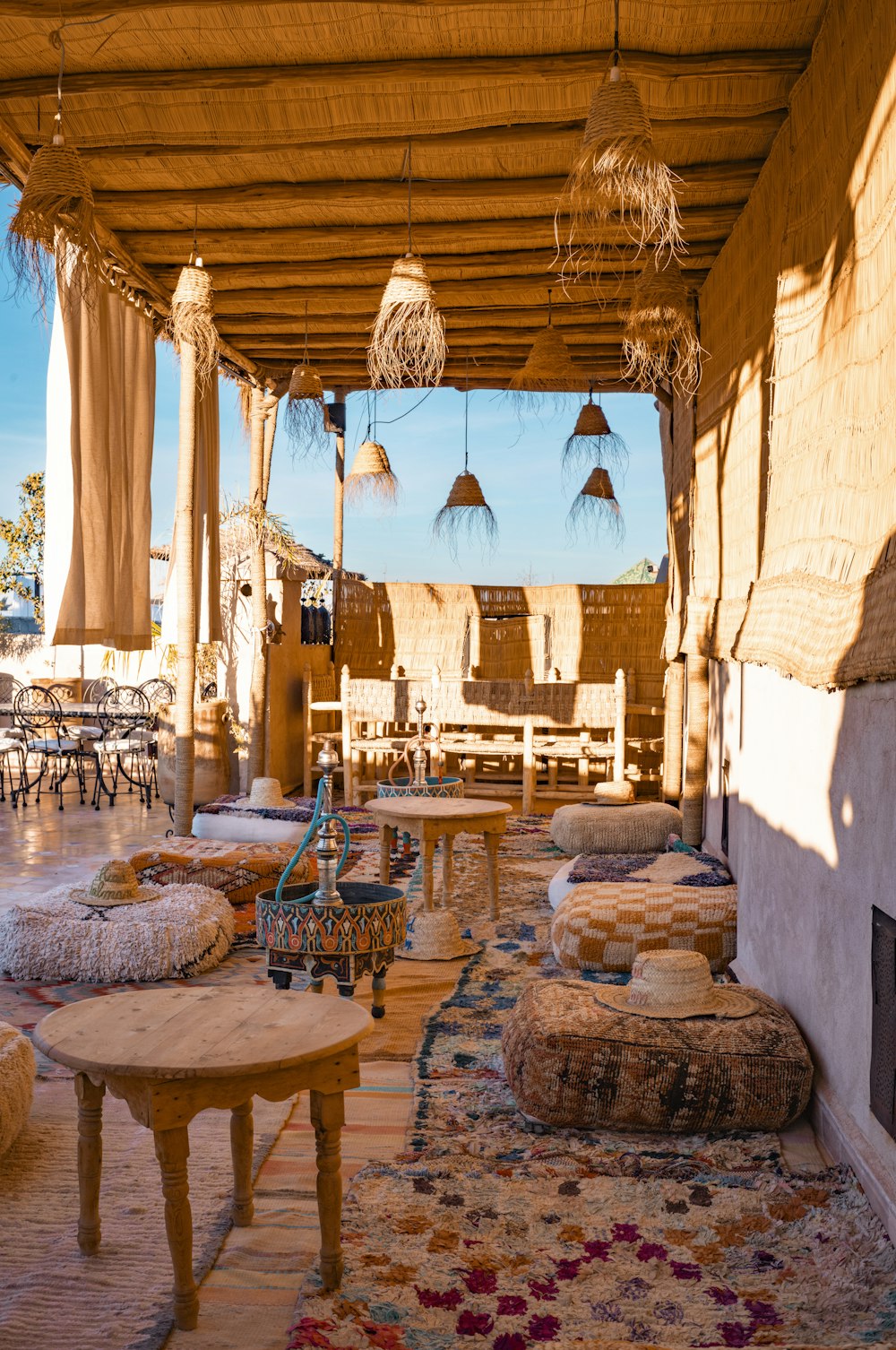 a covered patio area with tables and chairs