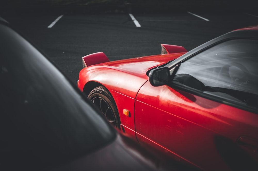 a red sports car parked in a parking lot