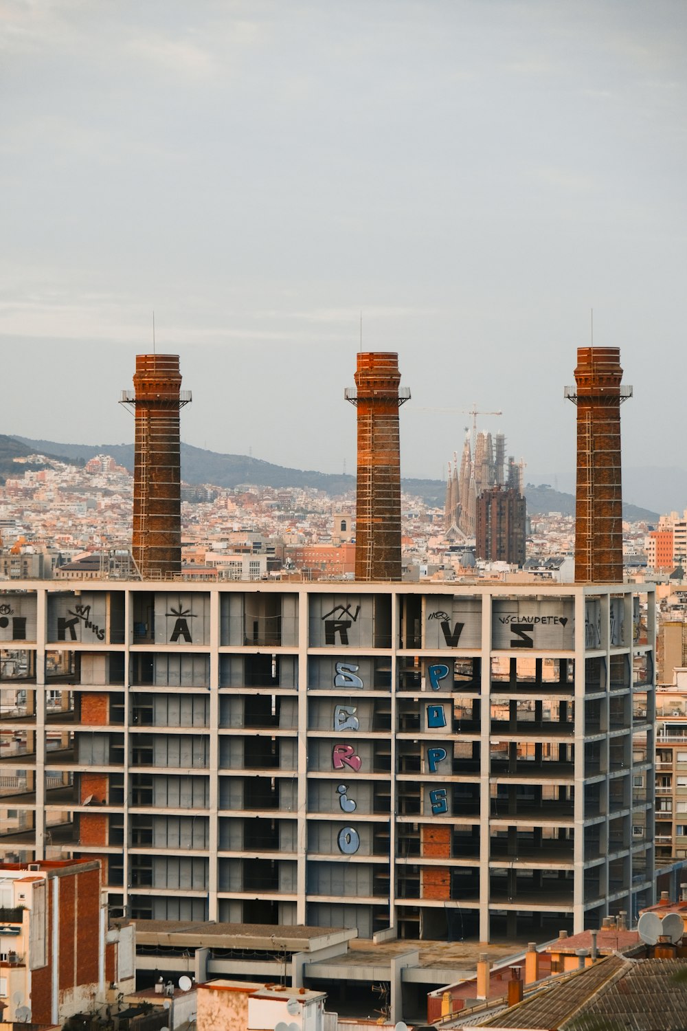 a very tall building with some chimneys on top of it