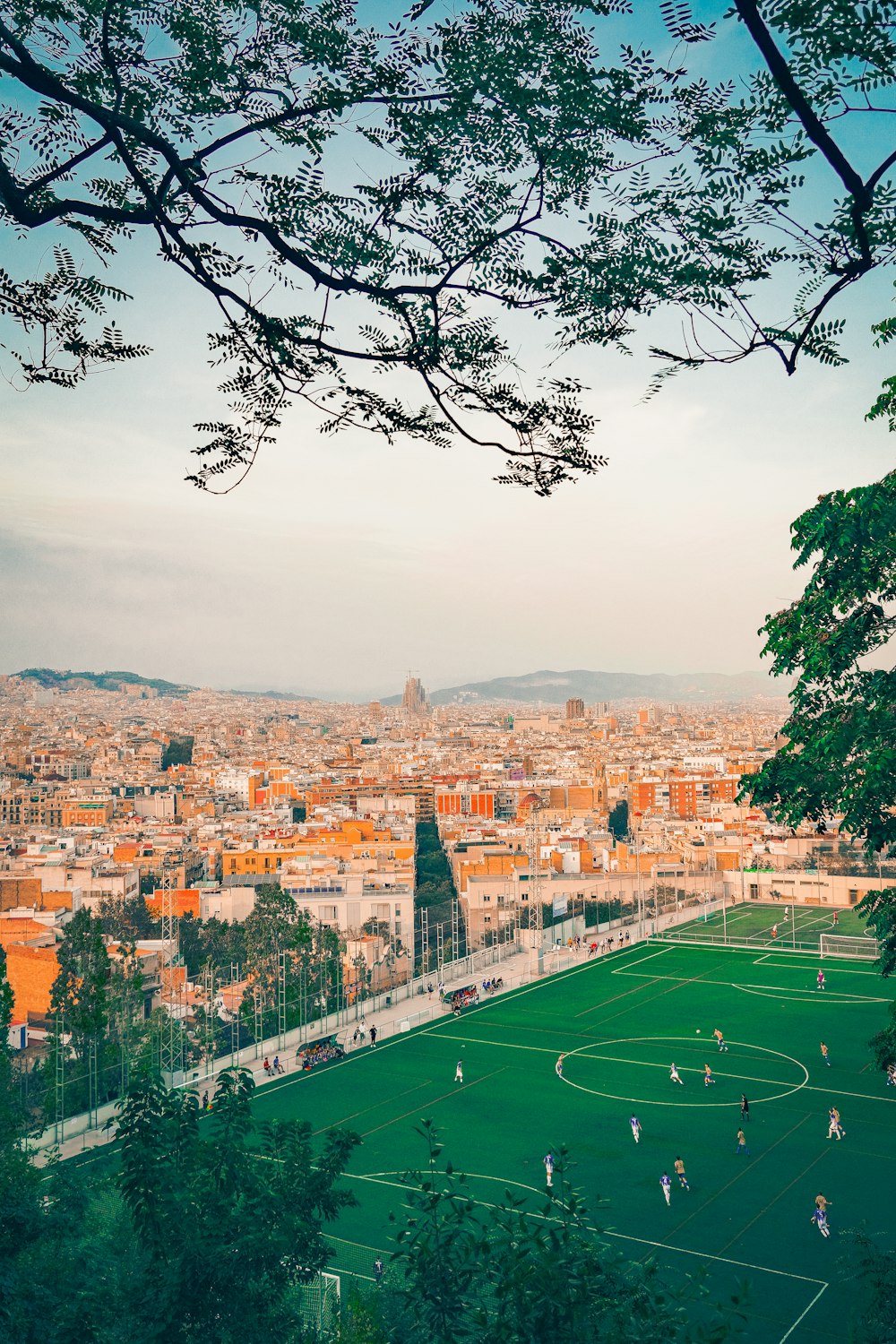 a soccer field with a view of a city