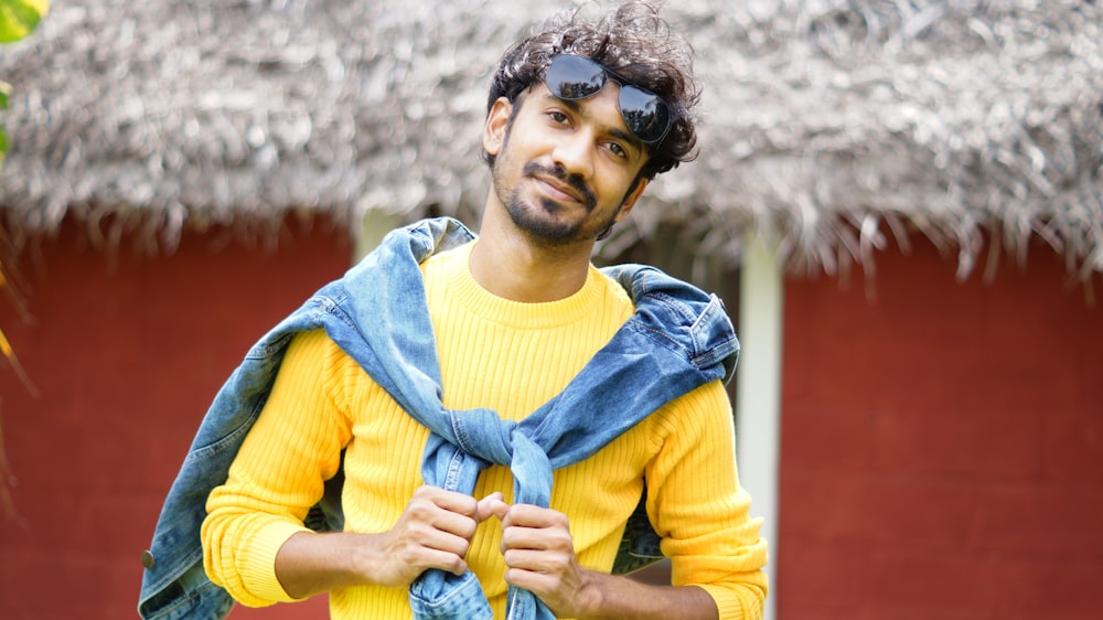 a man in a yellow shirt and blue scarf