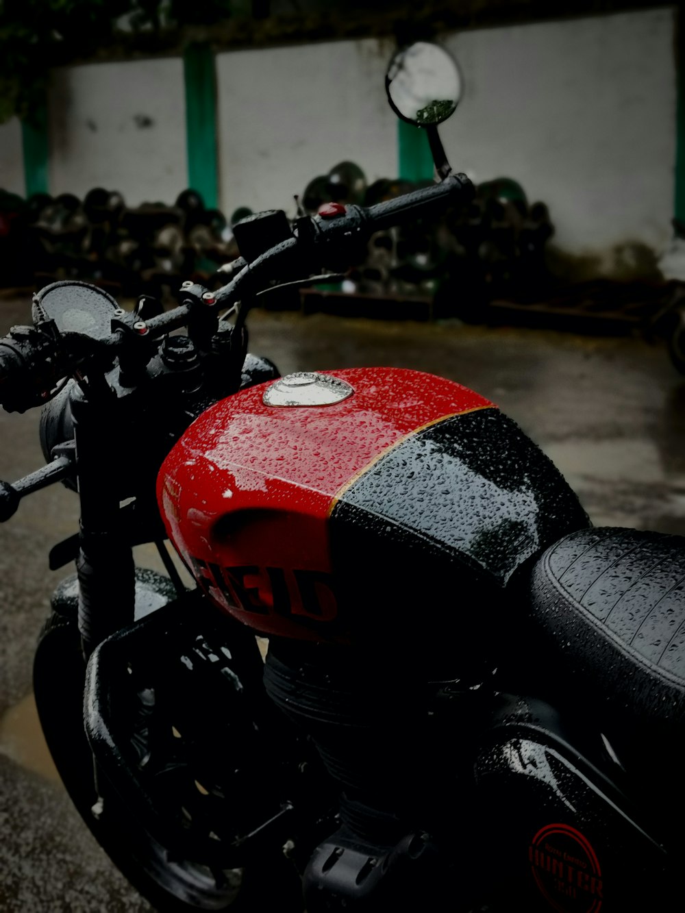 a red and black motorcycle parked in a parking lot