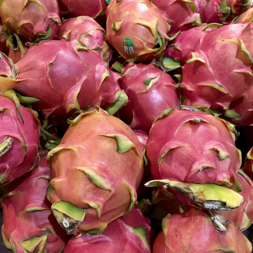 a pile of dragon fruit sitting next to each other