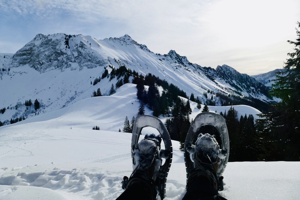 a pair of skis sitting on top of a snow covered slope