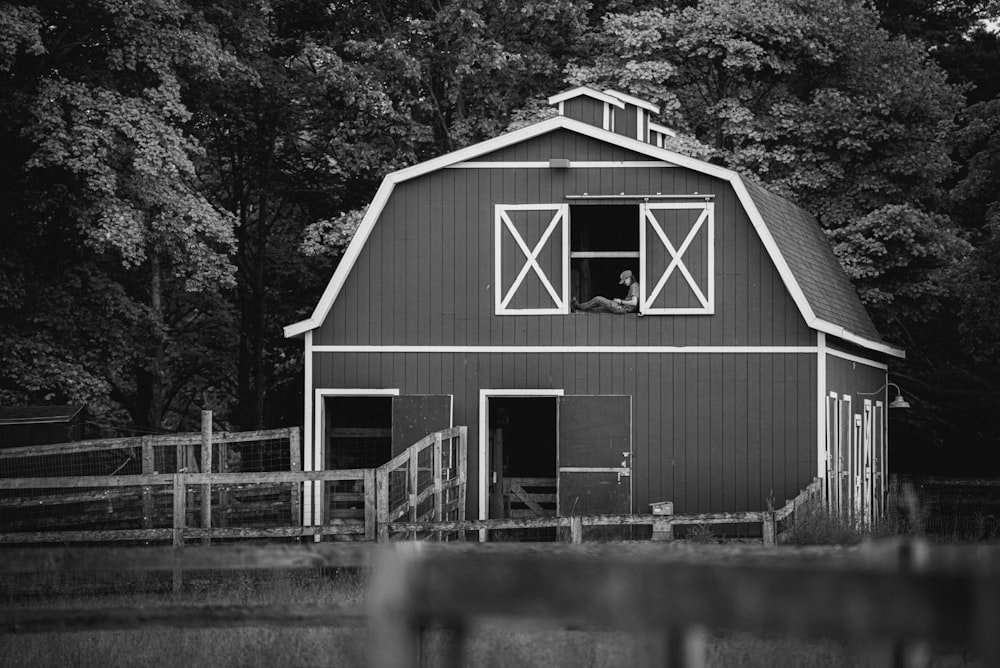 a black and white photo of a barn