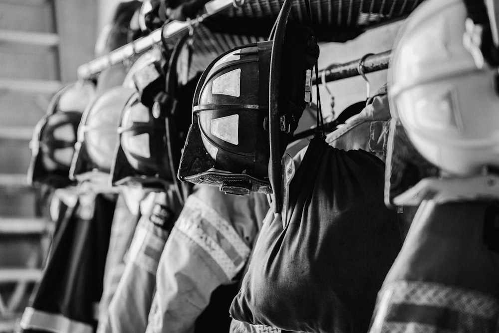 a row of fire fighters lined up against a wall