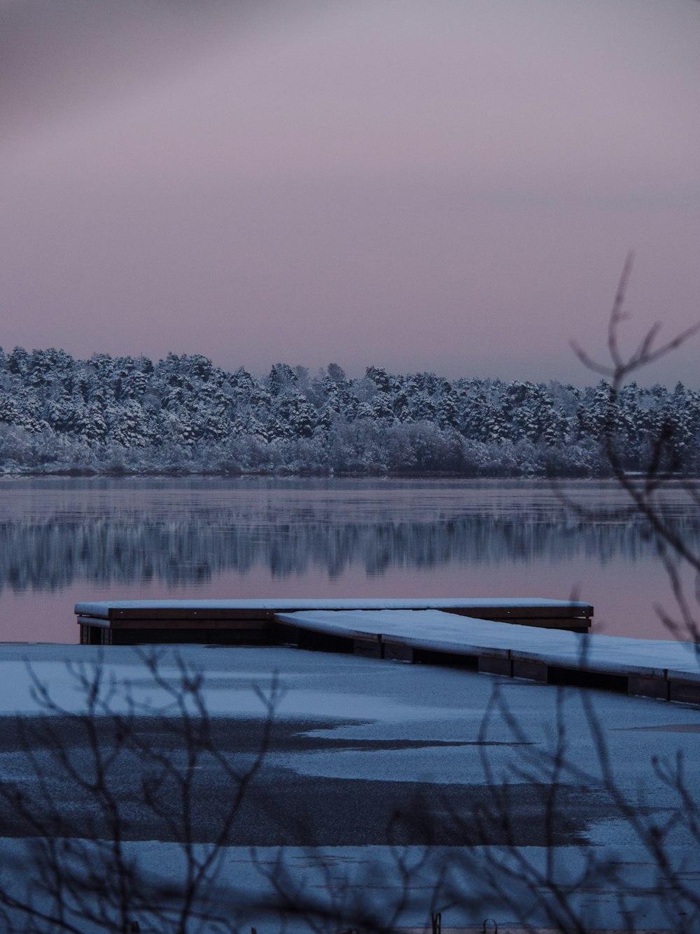 a body of water with a dock in the middle of it