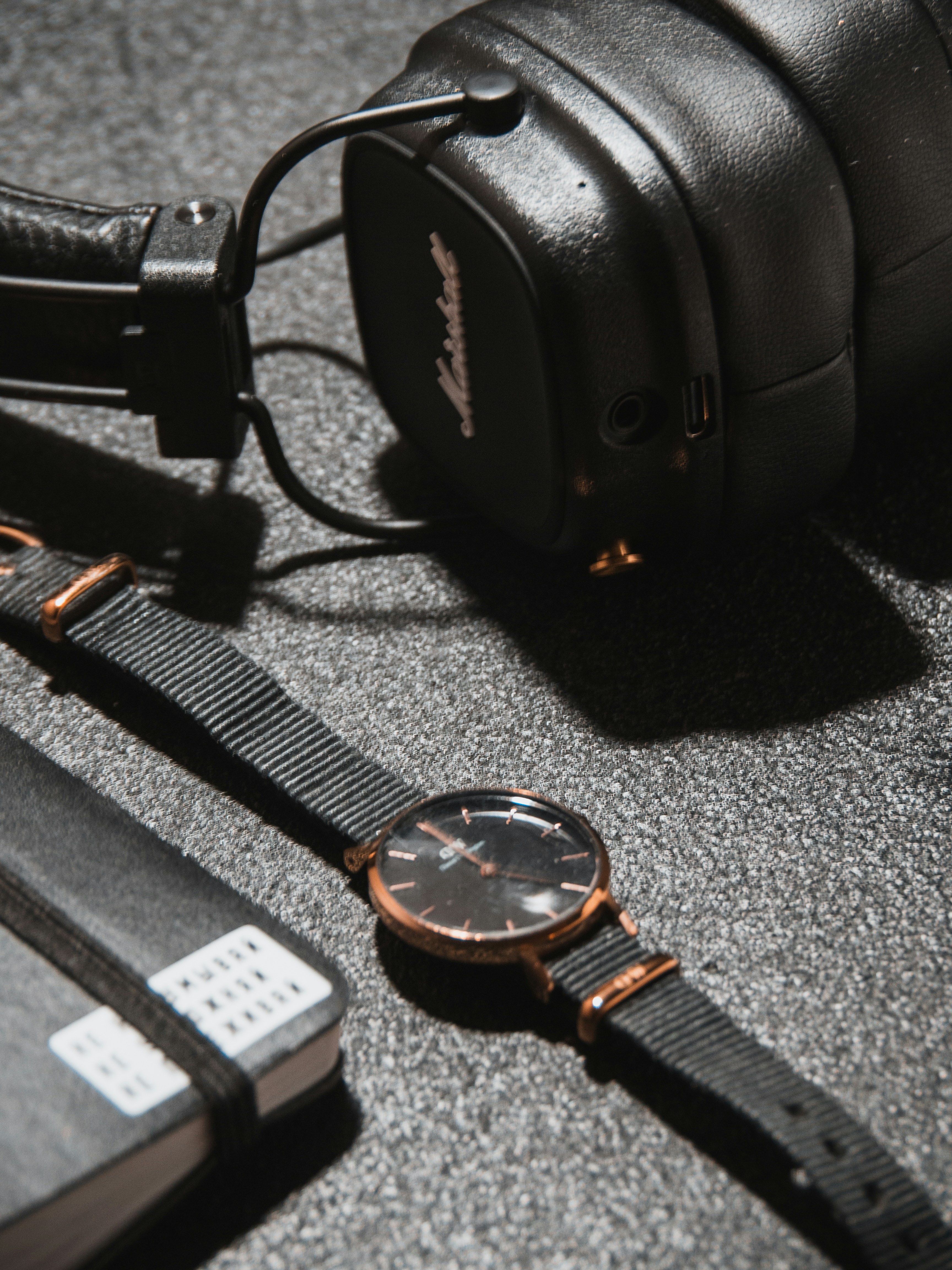 a pair of headphones and a watch on a table